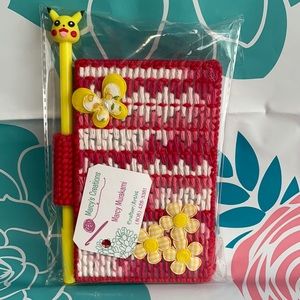 Red and Yellow notepad case and pikachu pen. 😊